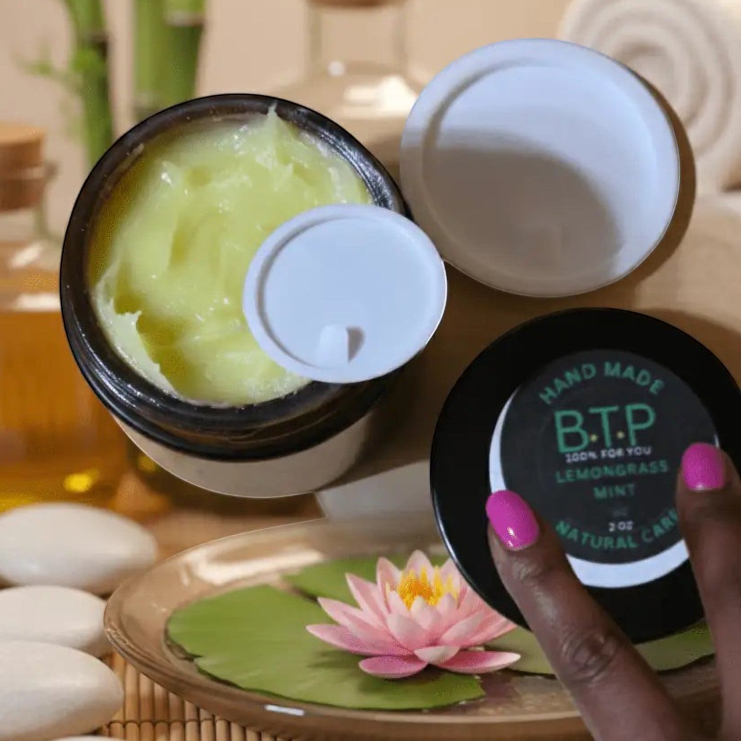 Infinite Storefront B.T.P handmade lemongrass and mint moisturizing body balm in a 2 oz jar with a spa-like setting.