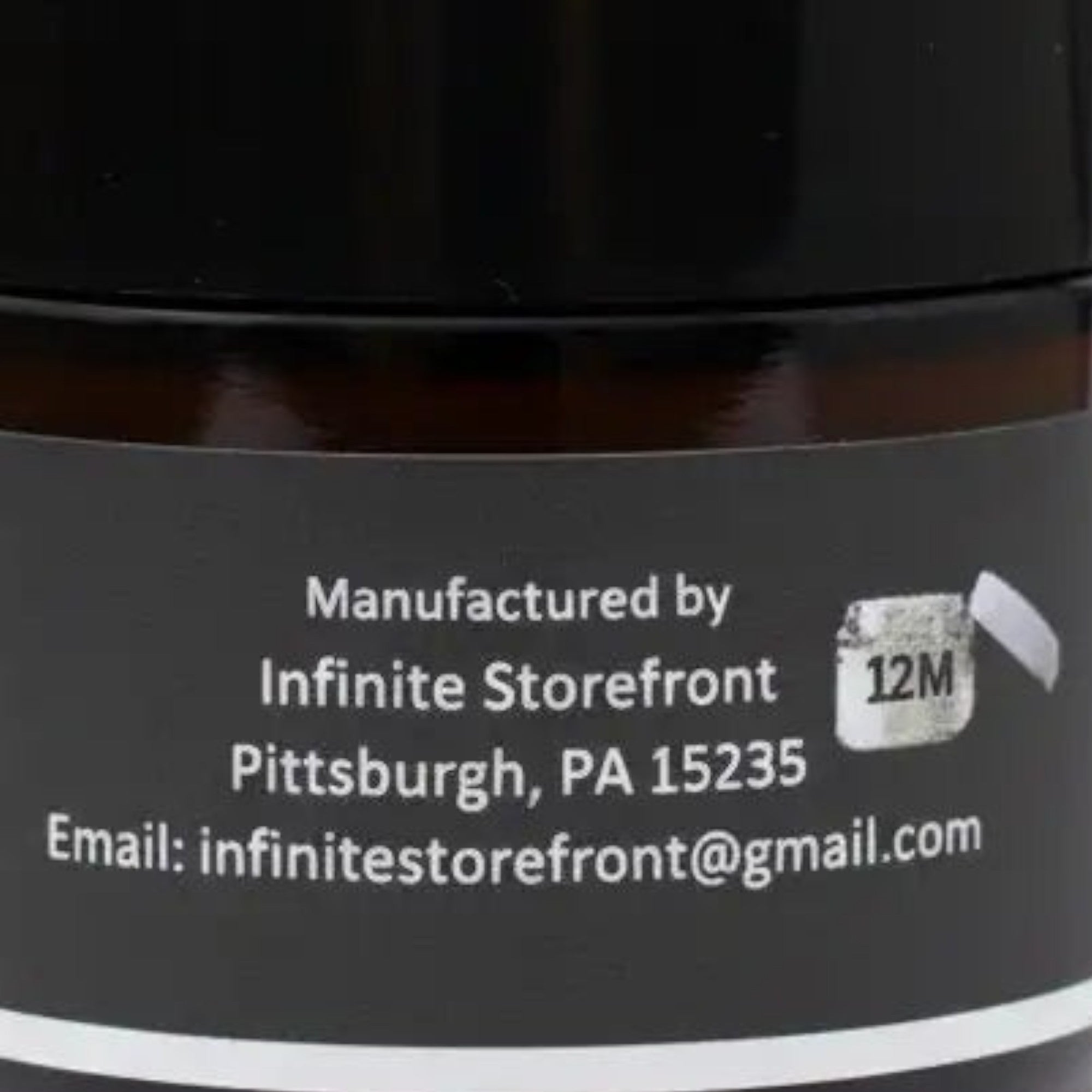 Infinite Storefront Btp Lemon Balm Mint Body Balm in an amber glass jar with a black lid, back label view.