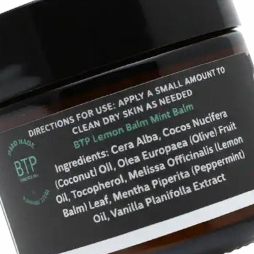 Infinite Storefront Btp Lemon Balm Mint body balm in an amber glass jar with a black lid showing ingredient label