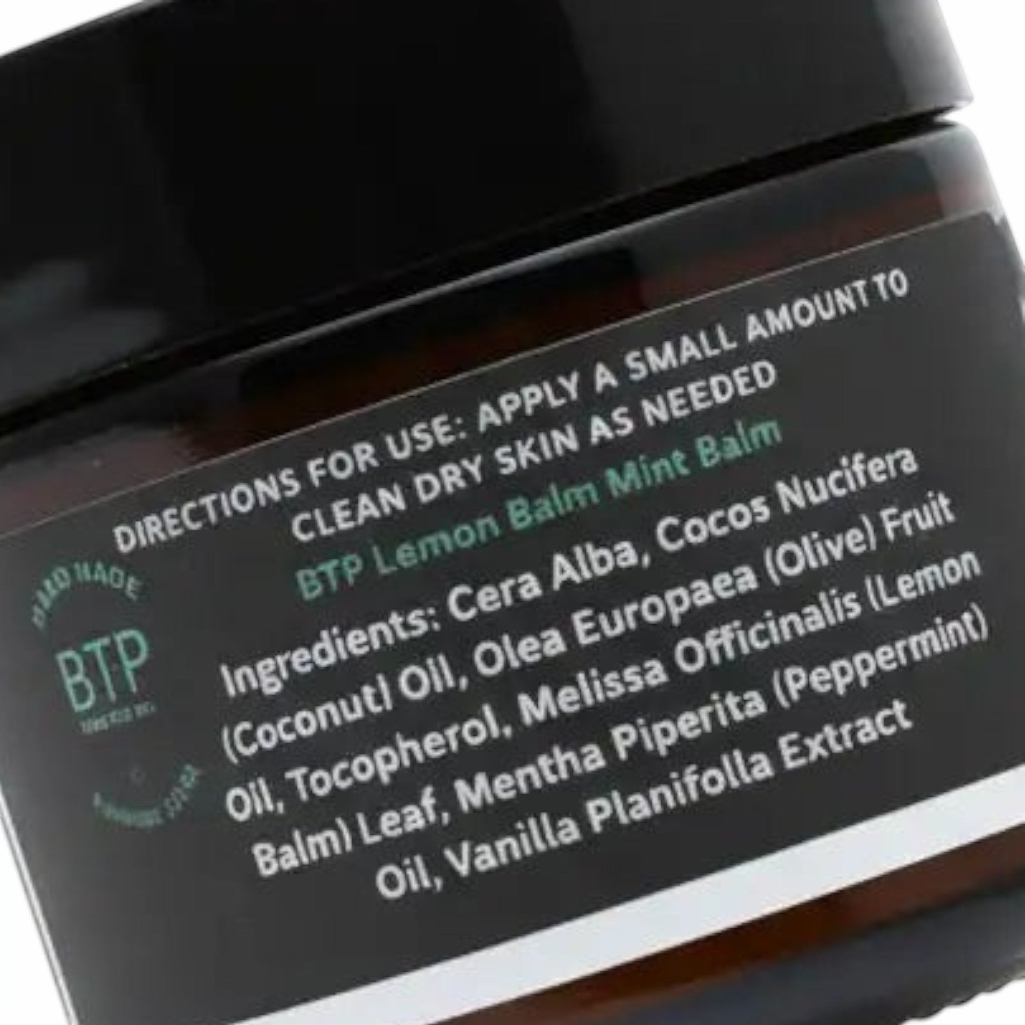 Infinite Storefront Btp Lemon Balm Mint body balm in an amber glass jar with a black lid showing ingredient label