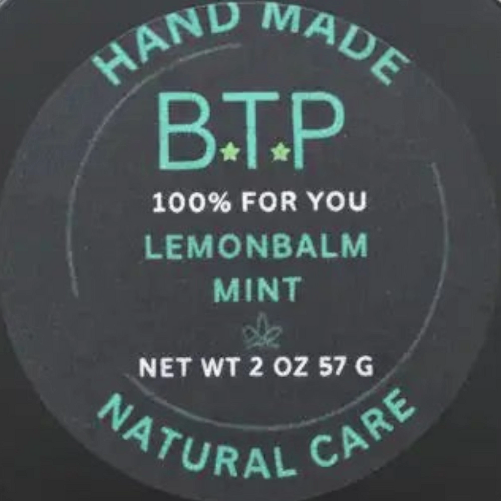 Infinite Storefront Btp Lemon Balm Mint body balm in a 2 oz black tin with a minimalist green and black label.